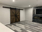 Living room featuring the Custom Double British Brace K Style Barn Door in Jacobean stain.