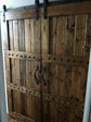 Double wooden sliding barn doors with metal handles from Custom Double Horizon Barn Door Package