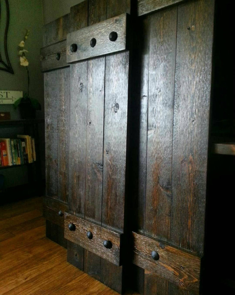 Large door framed by rustic cedar shutters