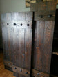 Three large doors adorned with rustic cedar shutters and metal handles