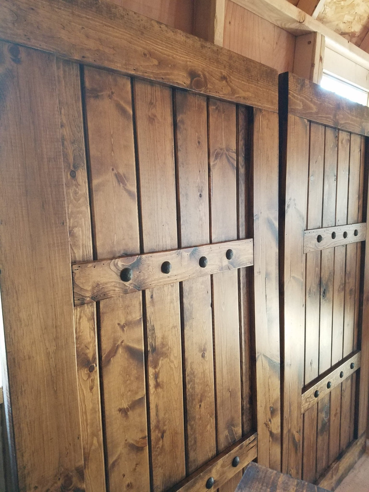 Pair of sliding wooden shutters with decorative cut-outs