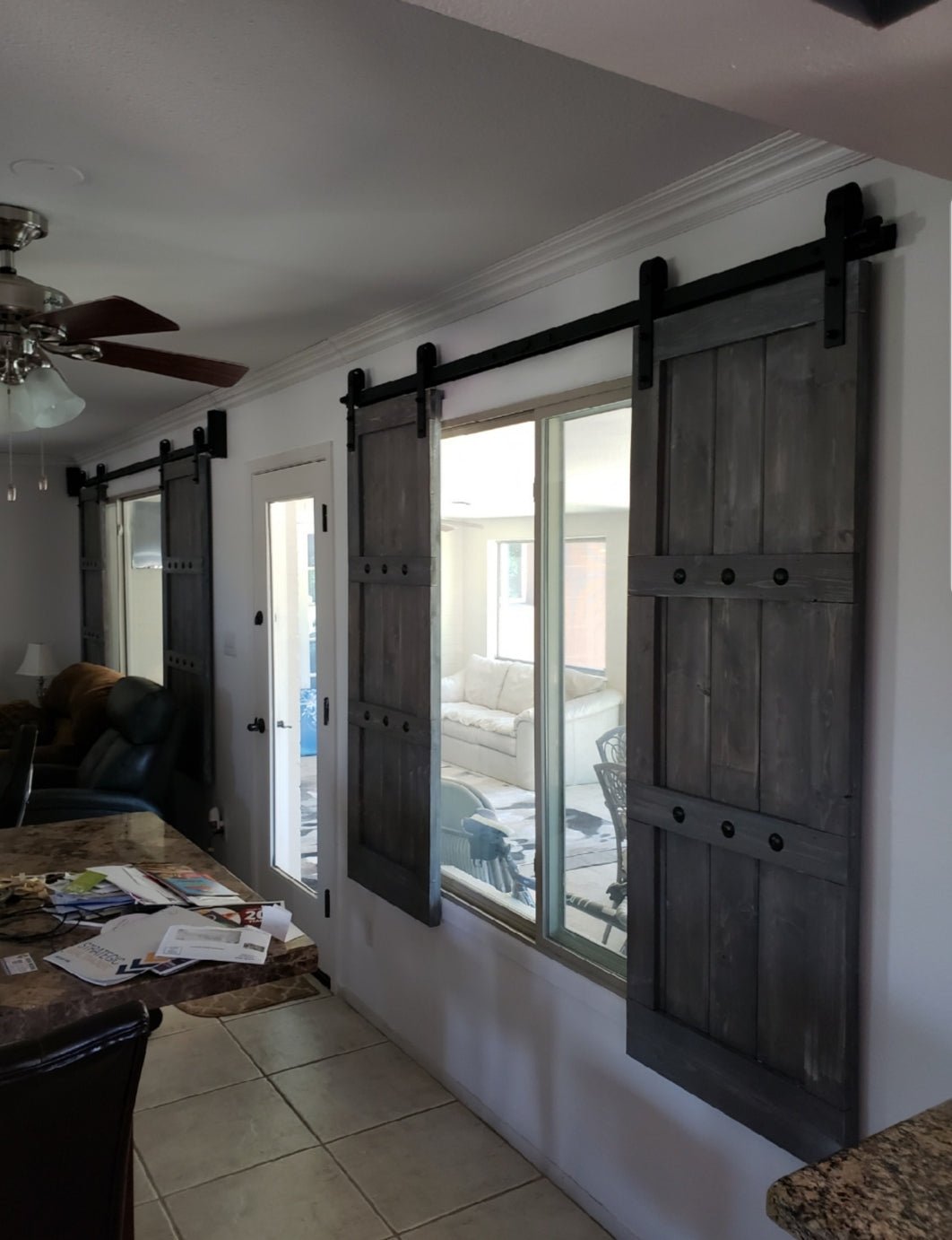 Kitchen and dining room separated by sliding barn shutters