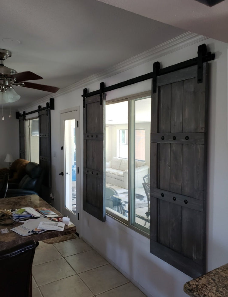 Kitchen and dining room separated by sliding barn shutters