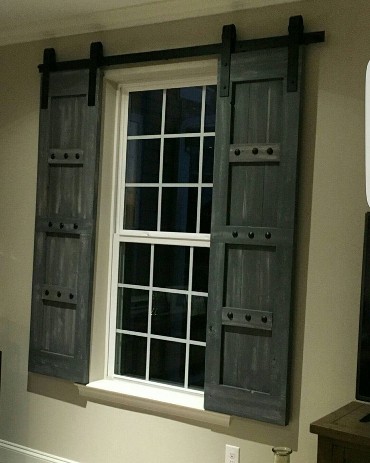 Television room window adorned with custom barn shutters