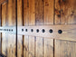 Detail view of wooden barn shutter with cut-out design and paneling