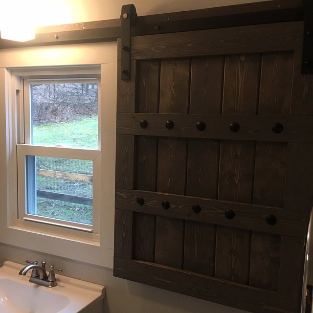 Bathroom featuring interior barn shutters