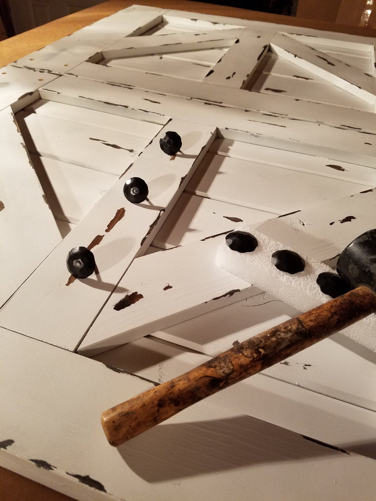 Close-up view of the wooden barn door with hardware details for TV cover